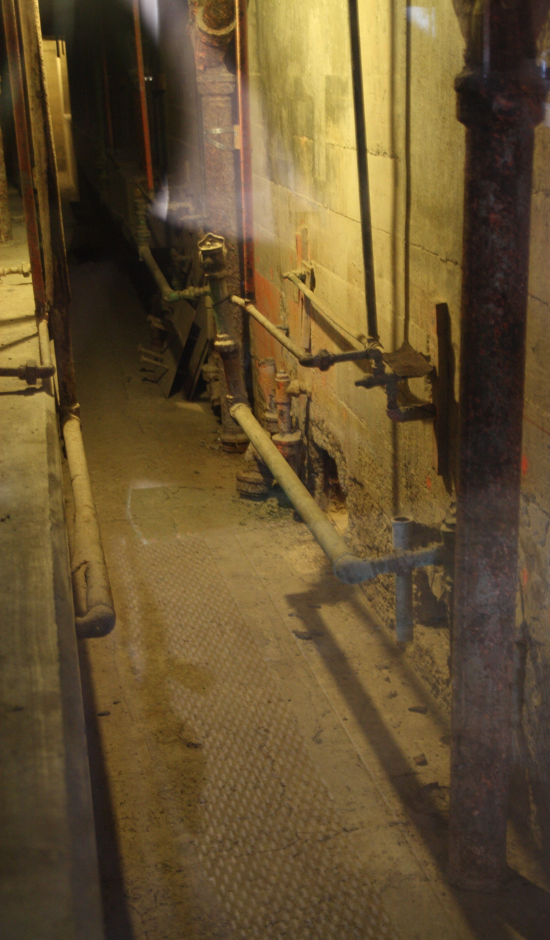 The utility corridor behind the cells in B Block at Alcatraz, showing two holes where Morris and the Anglins broke through
