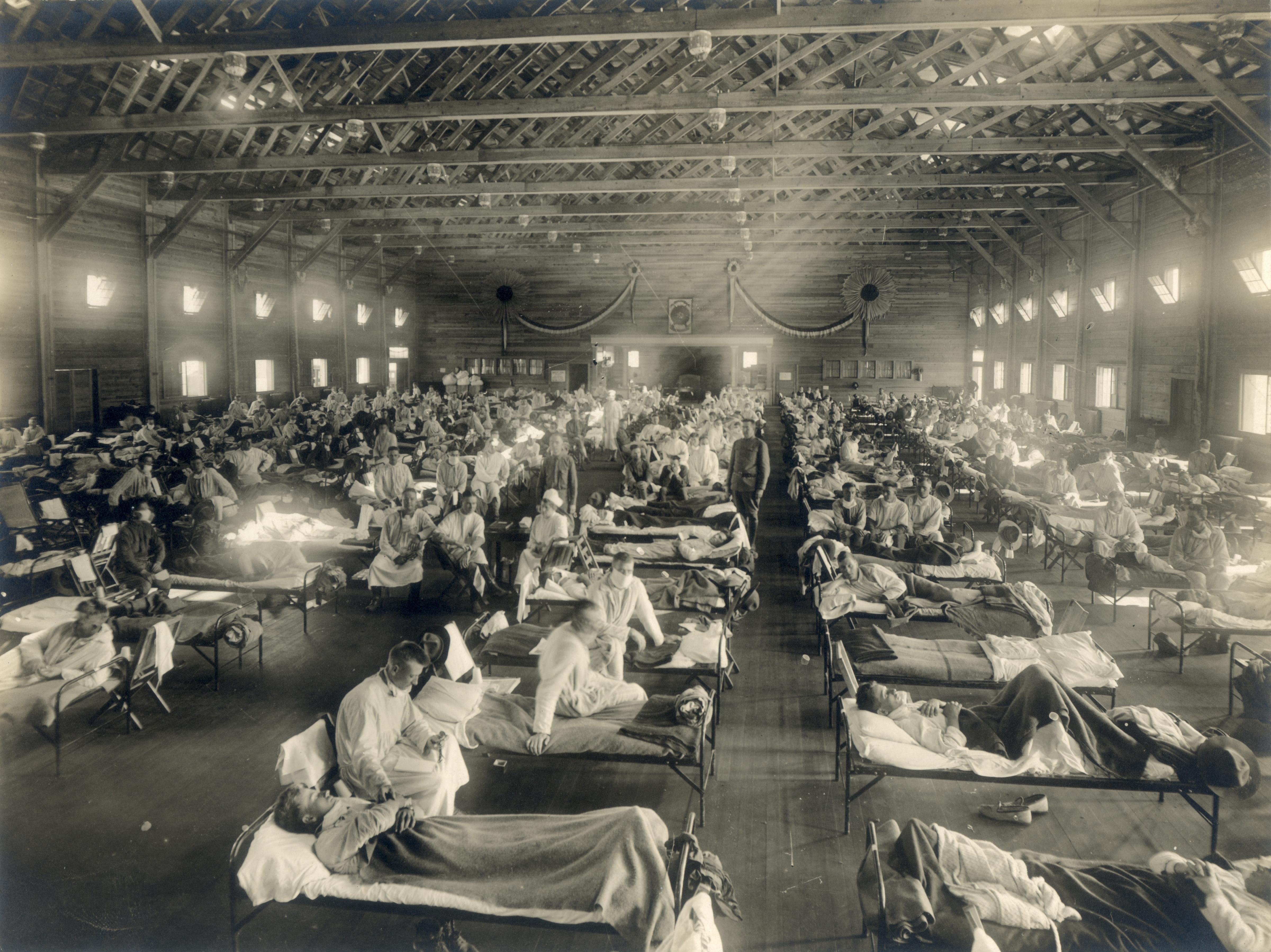 Emergency hospital ward at Camp Funston, Kansas, 1918, showing rows of beds with flu patients