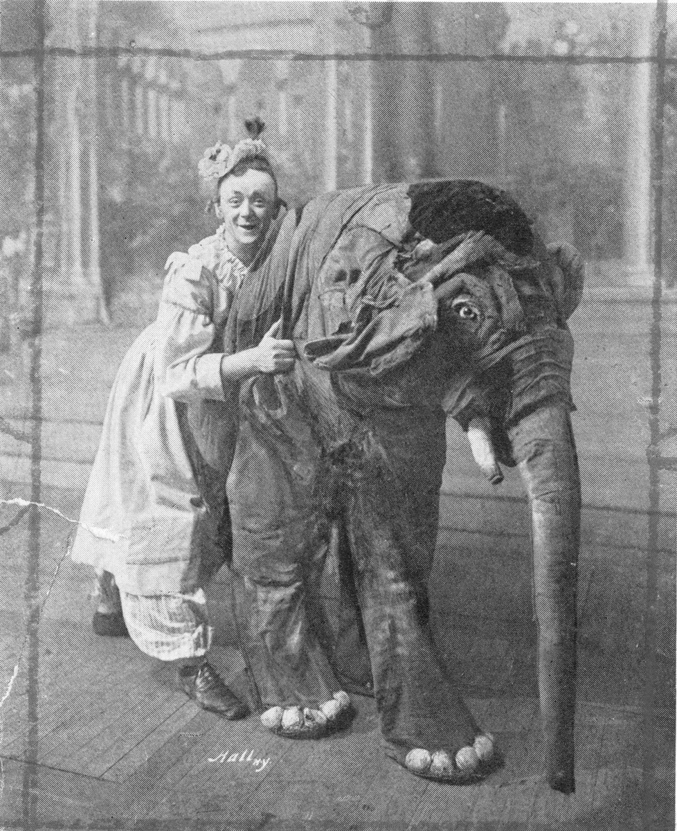 Eddie Foy in costume as Sister Anne in Mr. Blue Beard, posing with the pantomime elephant