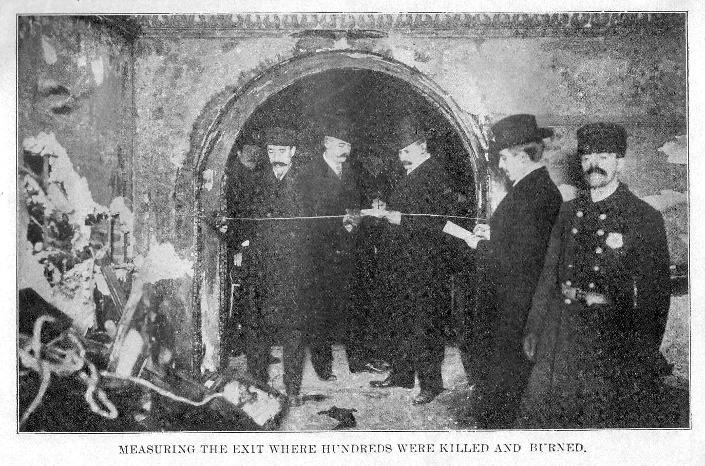Investigators measuring an exit of the Iroquois Theatre after the fire