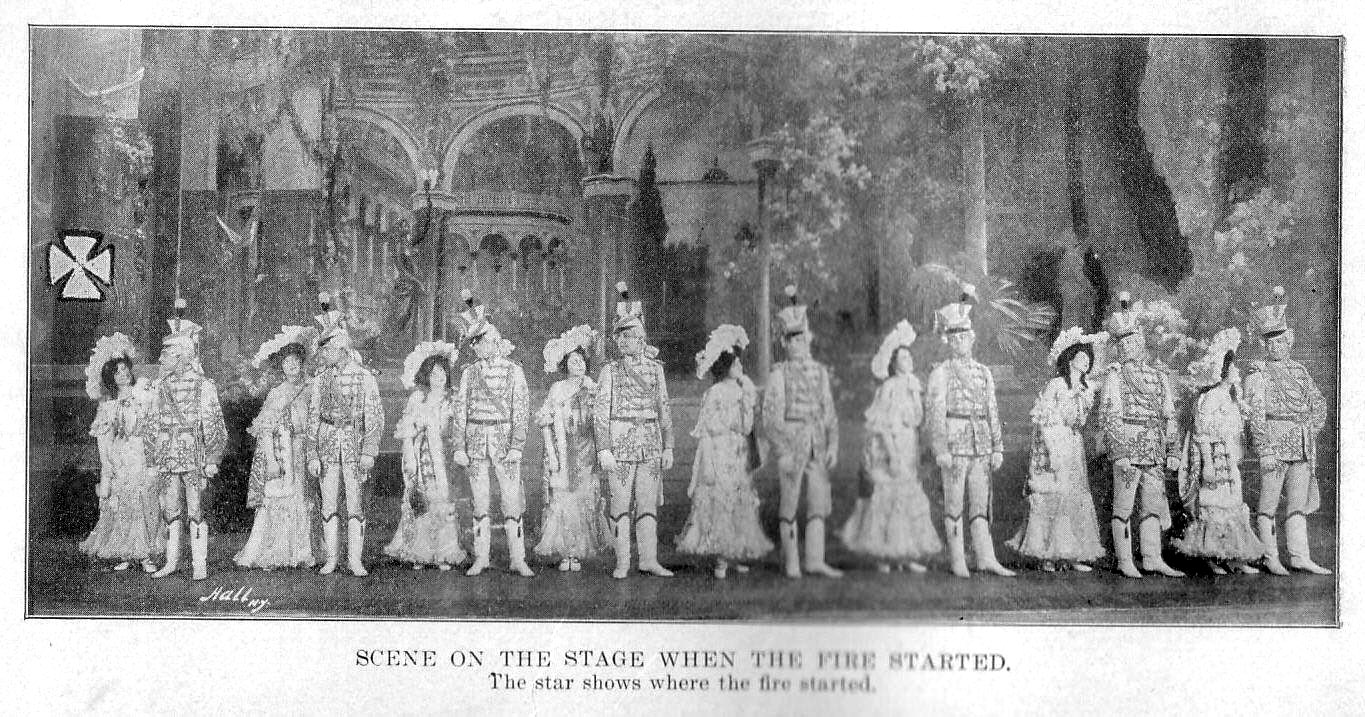 The cast of Mr. Blue Beard performing on the Iroquois stage, with a star marking where the fire started