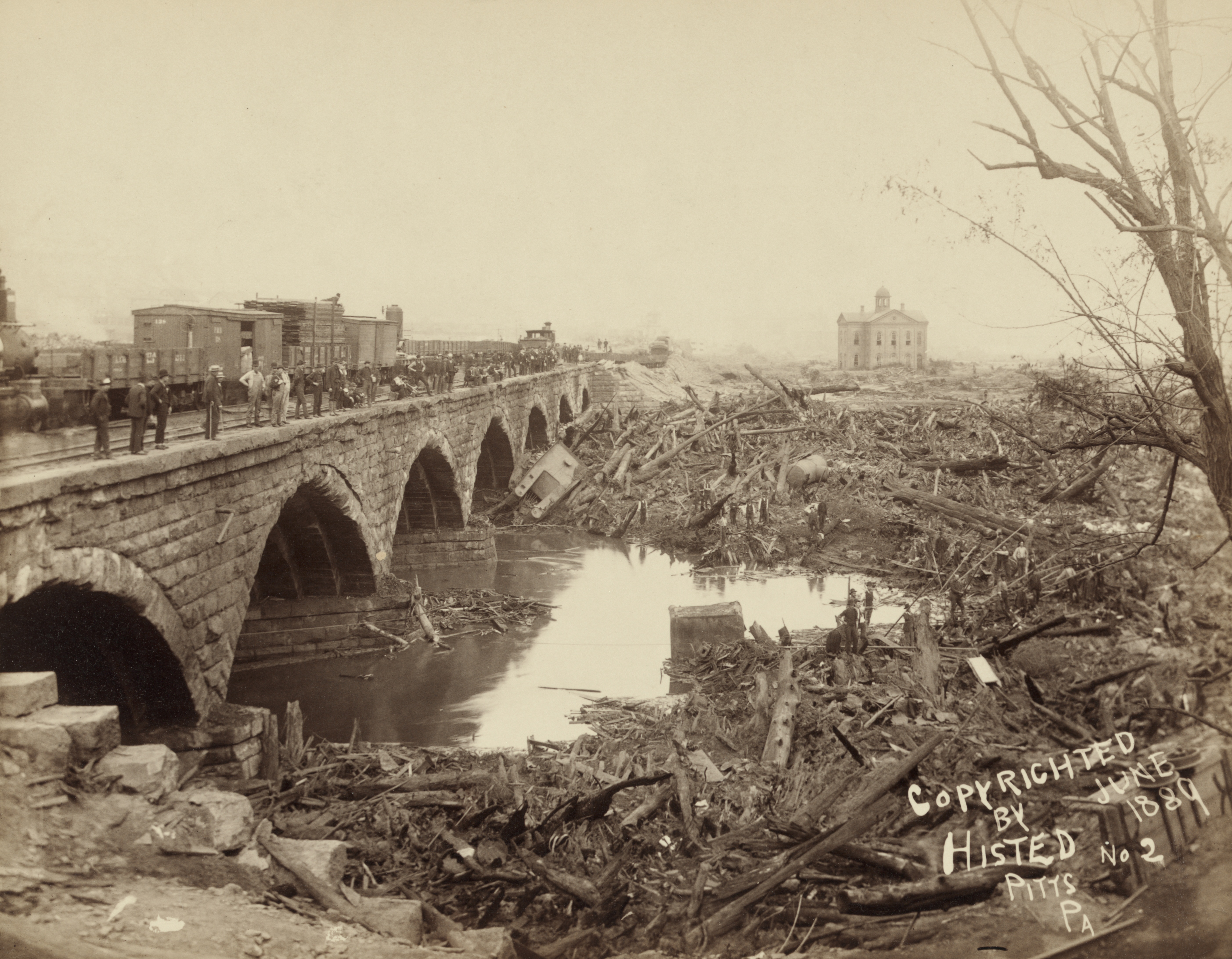 Debris piled against the PRR stone bridge at Johnstown, photographed by Ernest Walter Histed, May 1889