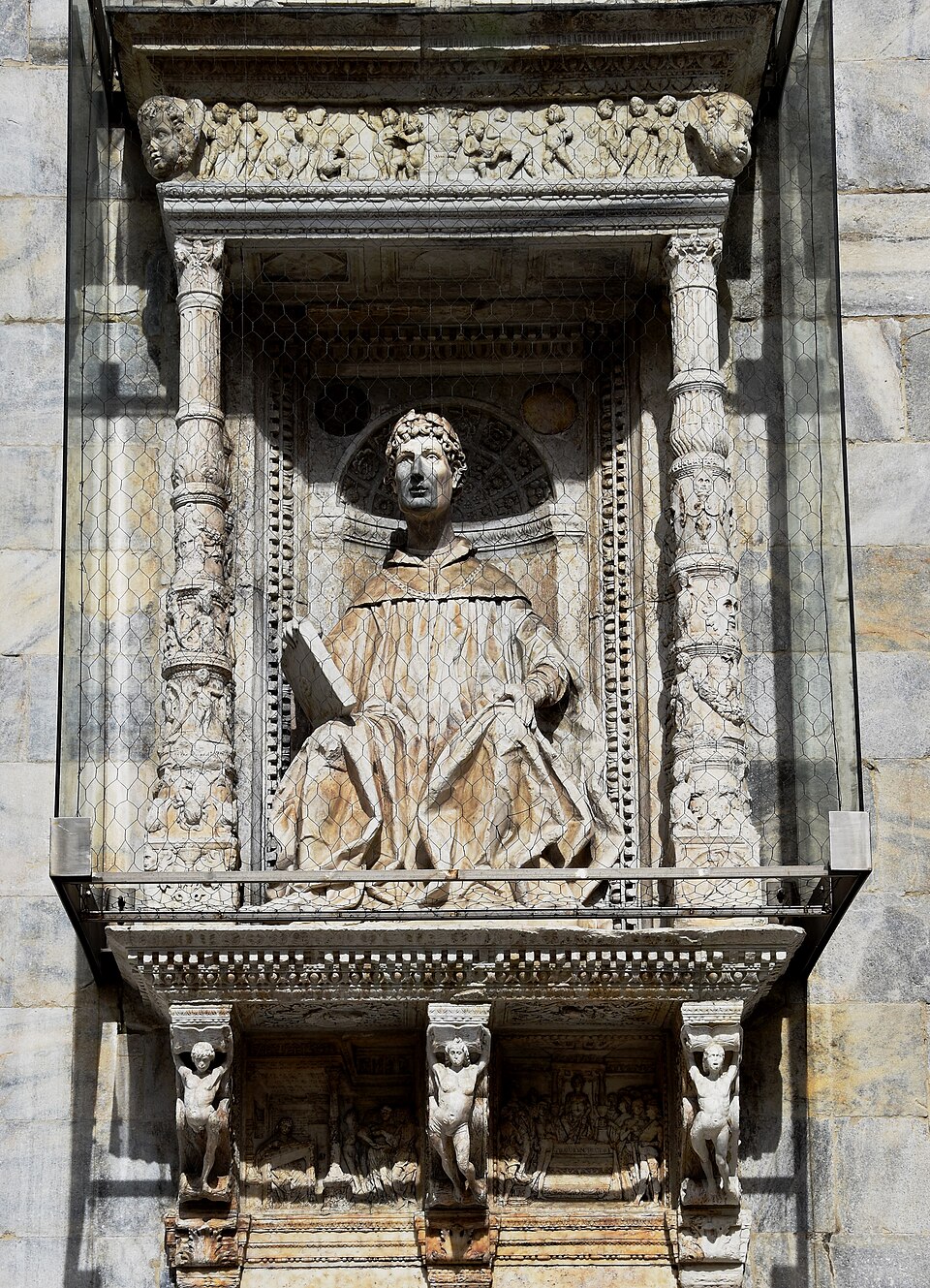Statue of Pliny the Younger on the facade of Como Cathedral in Italy
